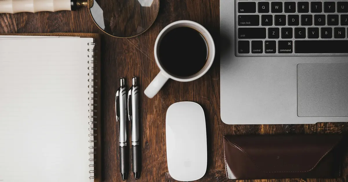 Cup of coffee near laptop